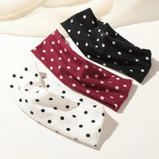 Three sports headbands in black, maroon, and white polka dots are displayed on a white surface.