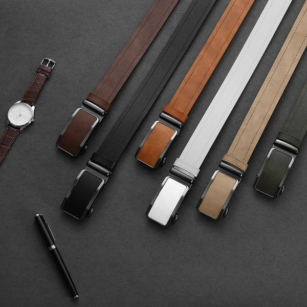 A collection of men's leather belts in various brown and gray tones displayed on a dark surface.