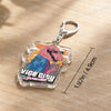 A clear acrylic keychain featuring a pink, stylized character from Vice City with a hanging metal ring.