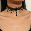 A black lace choker necklace featuring dark beads and a central black stone worn around the neck.