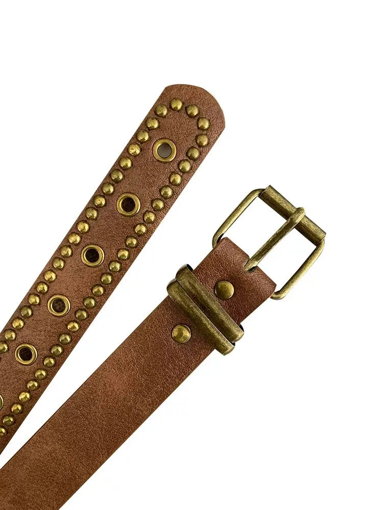 A close-up of a brown Western style PU belt with bronze rivets and a brass buckle.