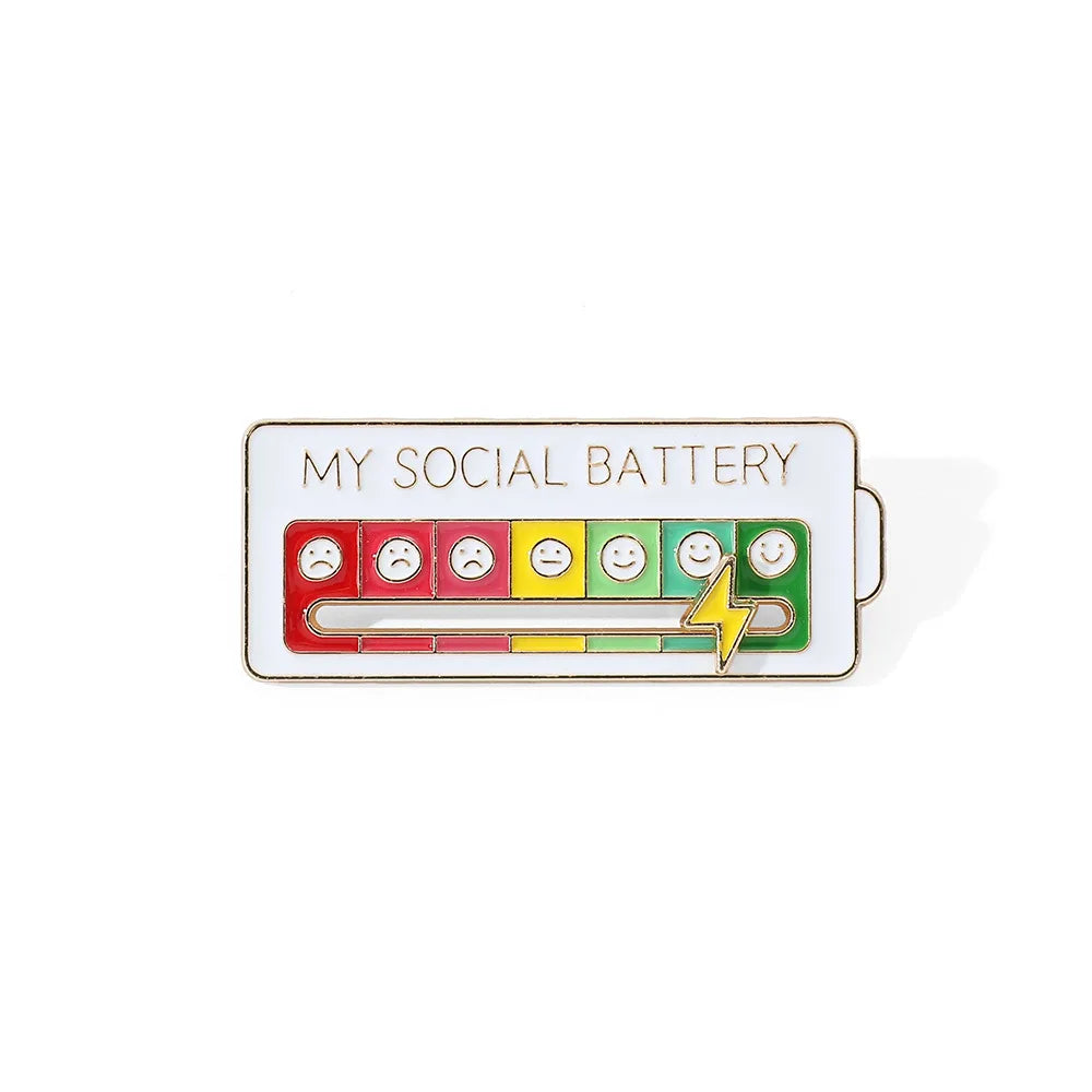 A rectangular enamel pin featuring a scale of facial expressions, ranging from sad to happy, labeled My Social Battery.
