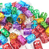 A collection of multicolor dreadlock hair rings in various shades including blue, green, purple, and gold.