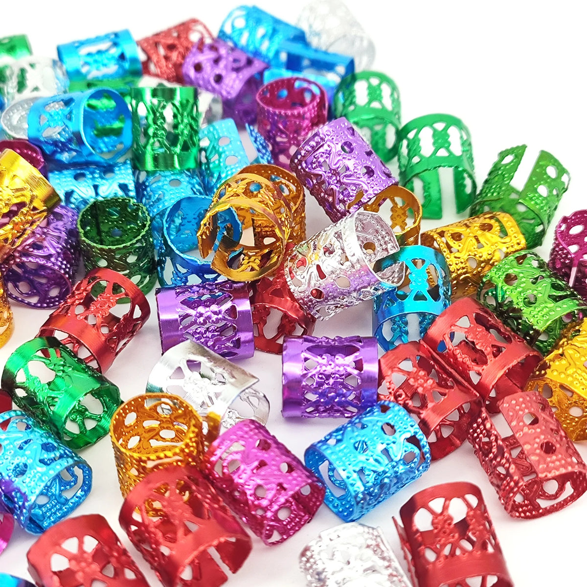 A collection of multicolor dreadlock hair rings in various shades including blue, green, purple, and gold.
