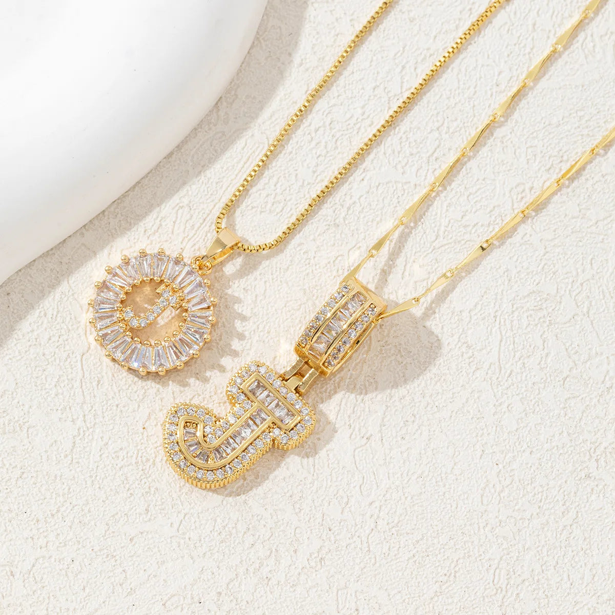 Gold necklace set featuring CZ crystal pendants shaped like the letters A and Z