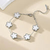 A silver gold plated stainless steel double-sided petal bracelet with a chain and four flower charms.