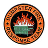 An enamel lapel pin featuring the text DUMPSTER FIRE RESPONSE TEAM in orange lettering surrounding a depiction of a fire abov