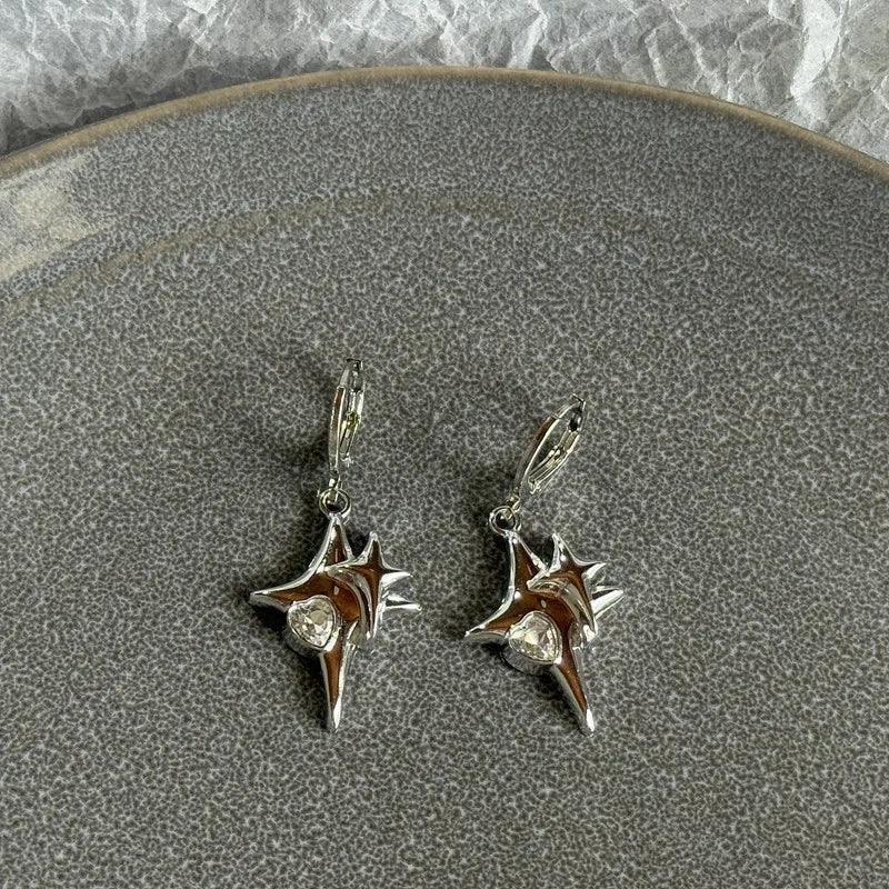 Silver stainless steel hoop earrings featuring a sun and moon design with clear stones.
