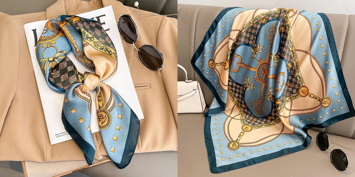 A floral print silk scarf in blue and gold tones is displayed next to a blazer.
