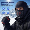 A man wearing a black versatile winter essential balaclava face mask and scarf in a snowy outdoor setting.