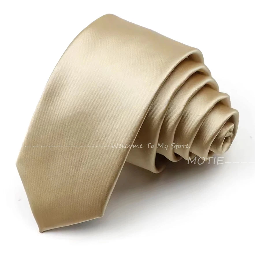 A rolled satin neck tie in a beige or champagne color, shown from the side.