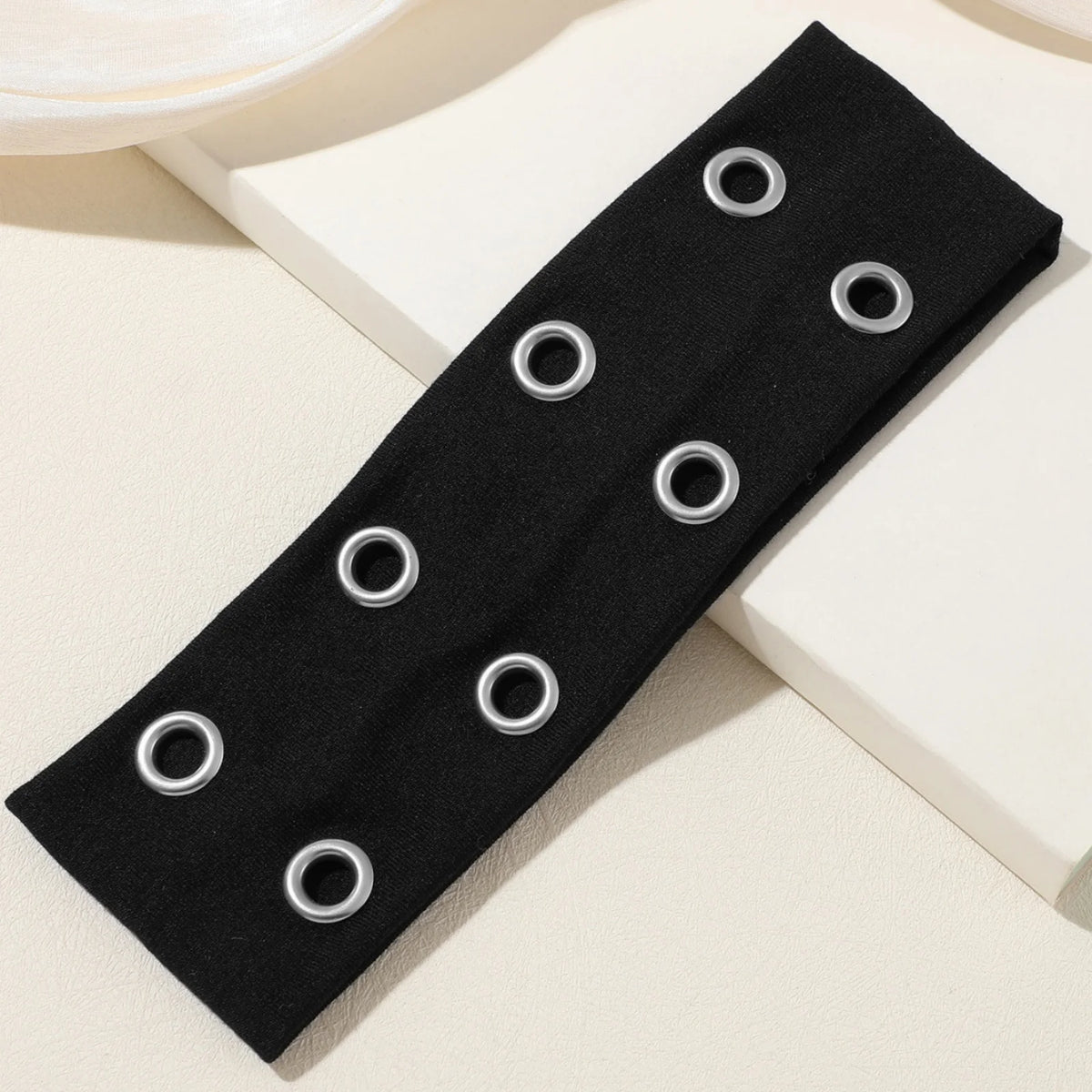 Black punk style metal hollow headband with multiple silver rings.
