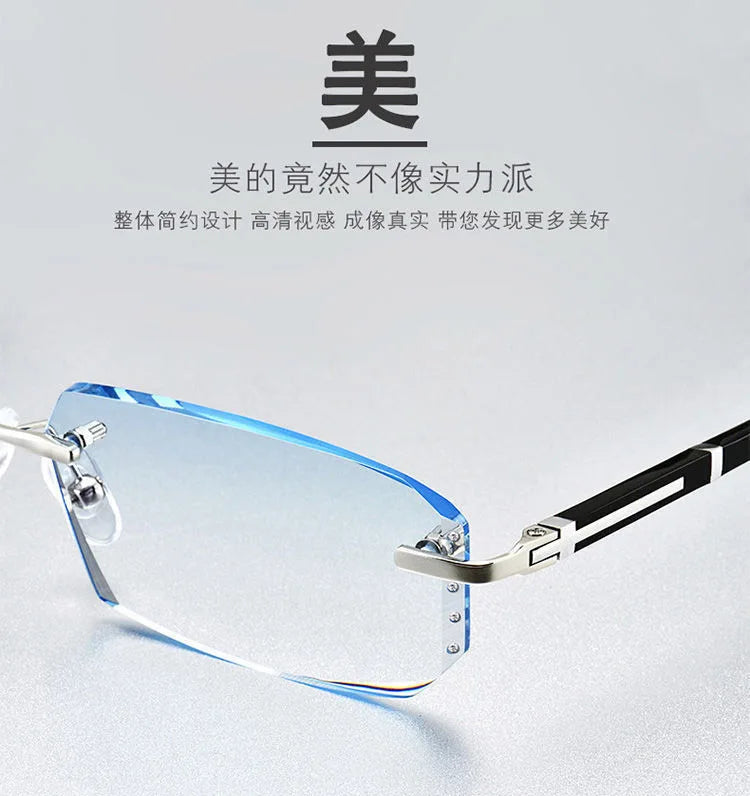 A pair of clear, frameless reading glasses with silver and black accents resting on a white surface.
