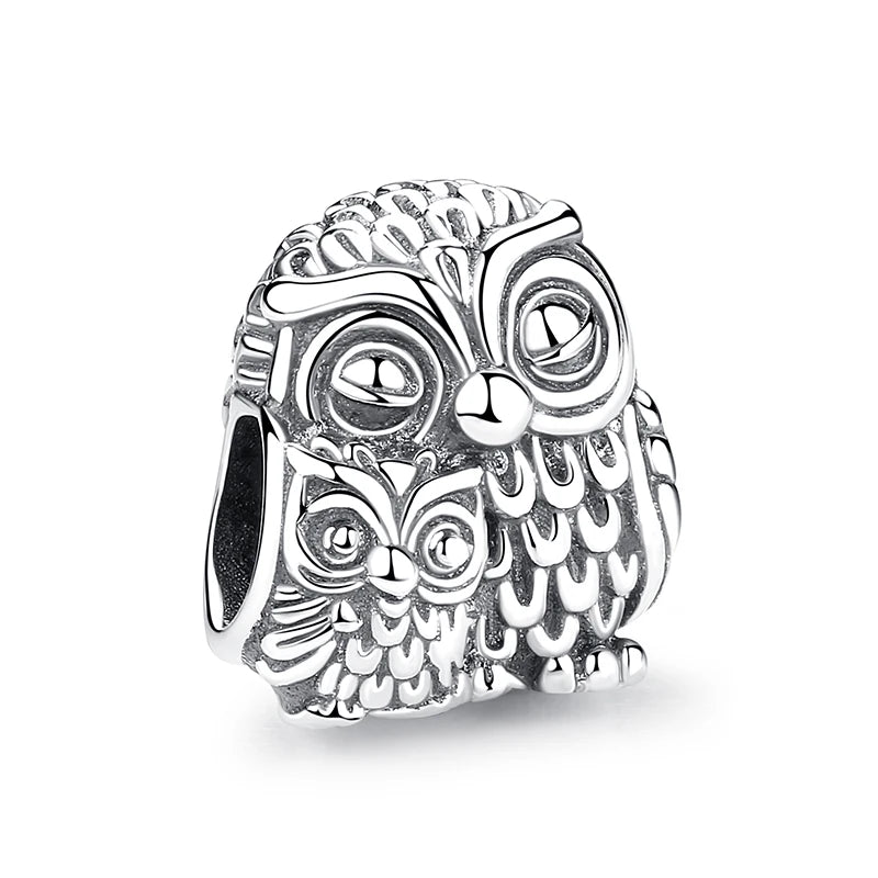 A detailed sterling silver owl charm featuring intricate feather and facial details.