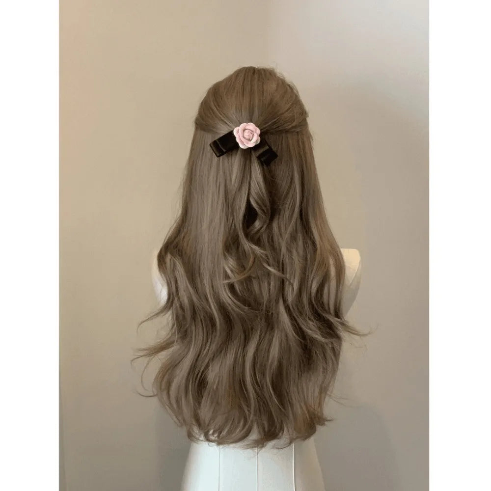 A long, wavy brown hair wig styled with a pink flower accessory.