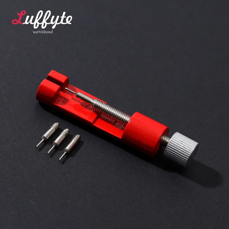A red watchband repair tool kit with a metal pin and adjustment mechanism is shown on a dark background.