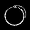 A crystal Cuban link anklet featuring gold and silver options, shown against a black background.