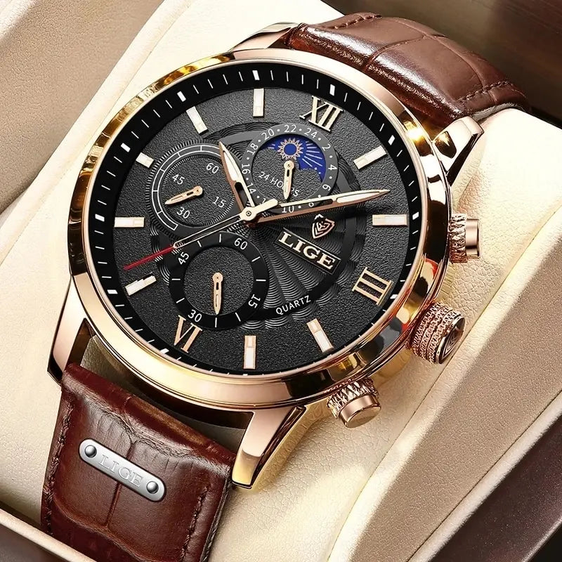 A close-up of a gold-toned men's quartz watch with a black dial and brown leather strap resting in a light-colored box.