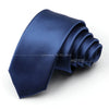A dark blue satin neck tie folded and displayed on a white background.