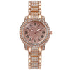 A rose gold quartz fashion watch with a pink dial and rhinestone accents on the band.