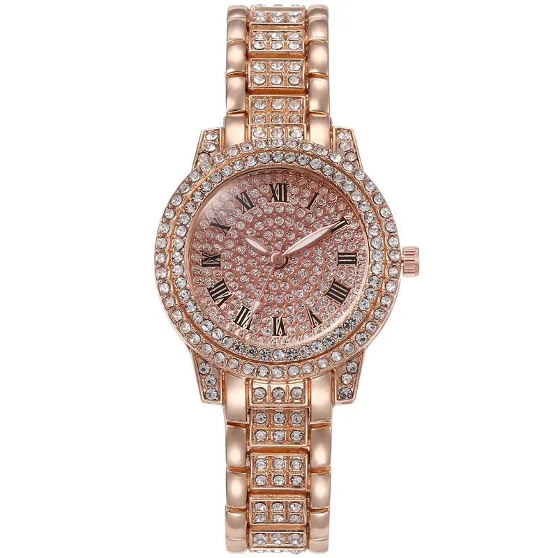 A rose gold quartz fashion watch with a pink dial and rhinestone accents on the band.