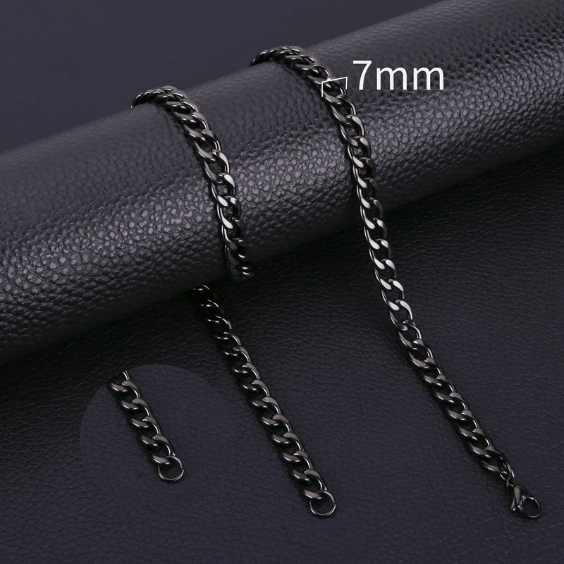 A close-up of a black stainless steel Cuban link necklace with a 7mm chain shown on a dark background.