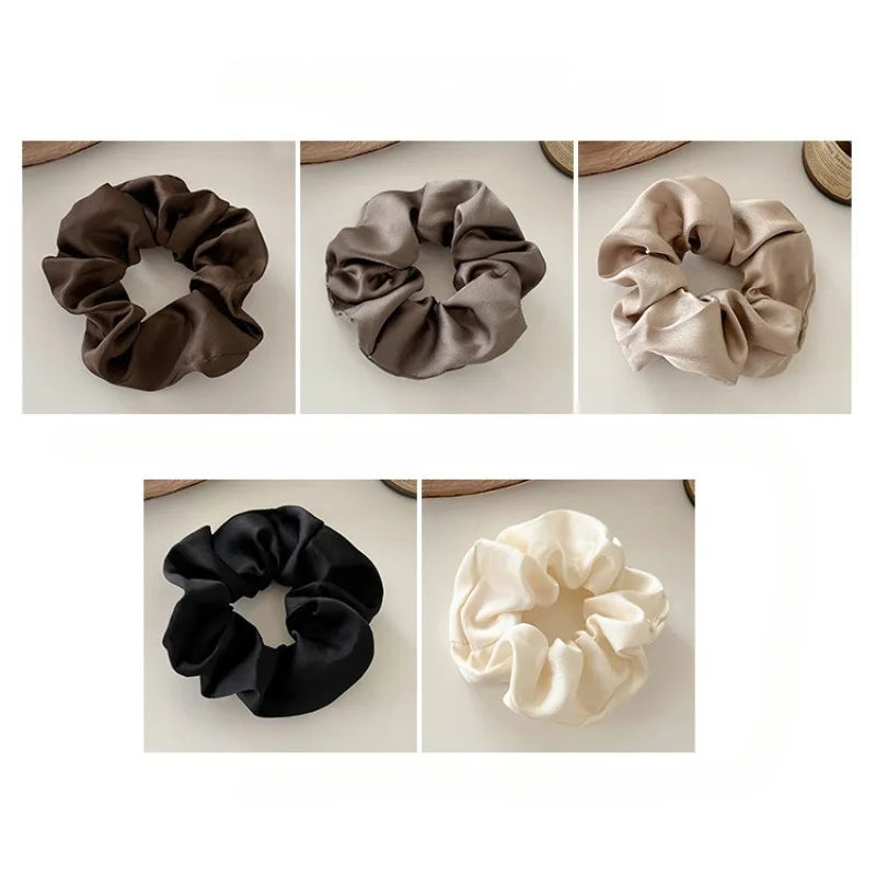 Five silk scrunchie hair ties in various shades of brown, beige, and black shown in a grid.