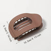 A flat, circular hair clip set in a matte brown color shown with dimensions.