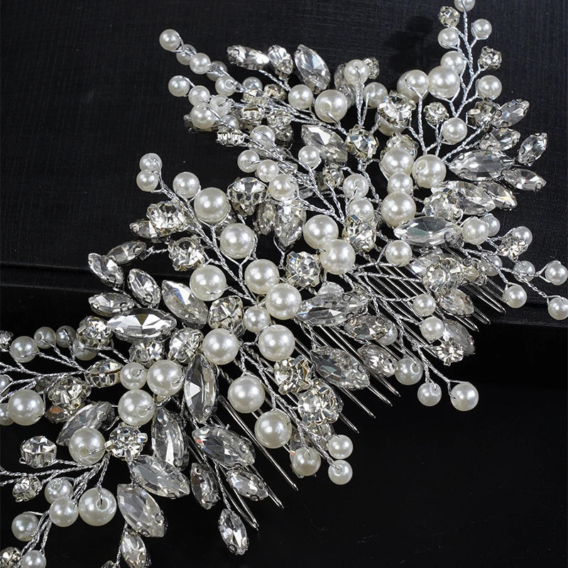 A delicate bridal headpiece featuring white pearls and clear rhinestones arranged in a floral design.