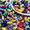 Assortment of colorful ceramic fish charms used for DIY jewelry making