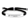 Black scripture quote bracelet with a silver bar and the text Be still and know that I am God Psalm 46:10 engraved on it.