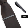 Black elegant men's tie clip shown attached to a dark patterned tie.