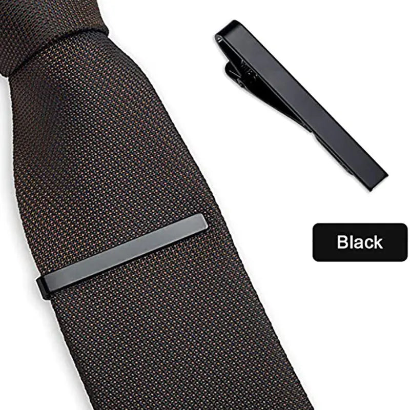 Black elegant men's tie clip shown attached to a dark patterned tie.