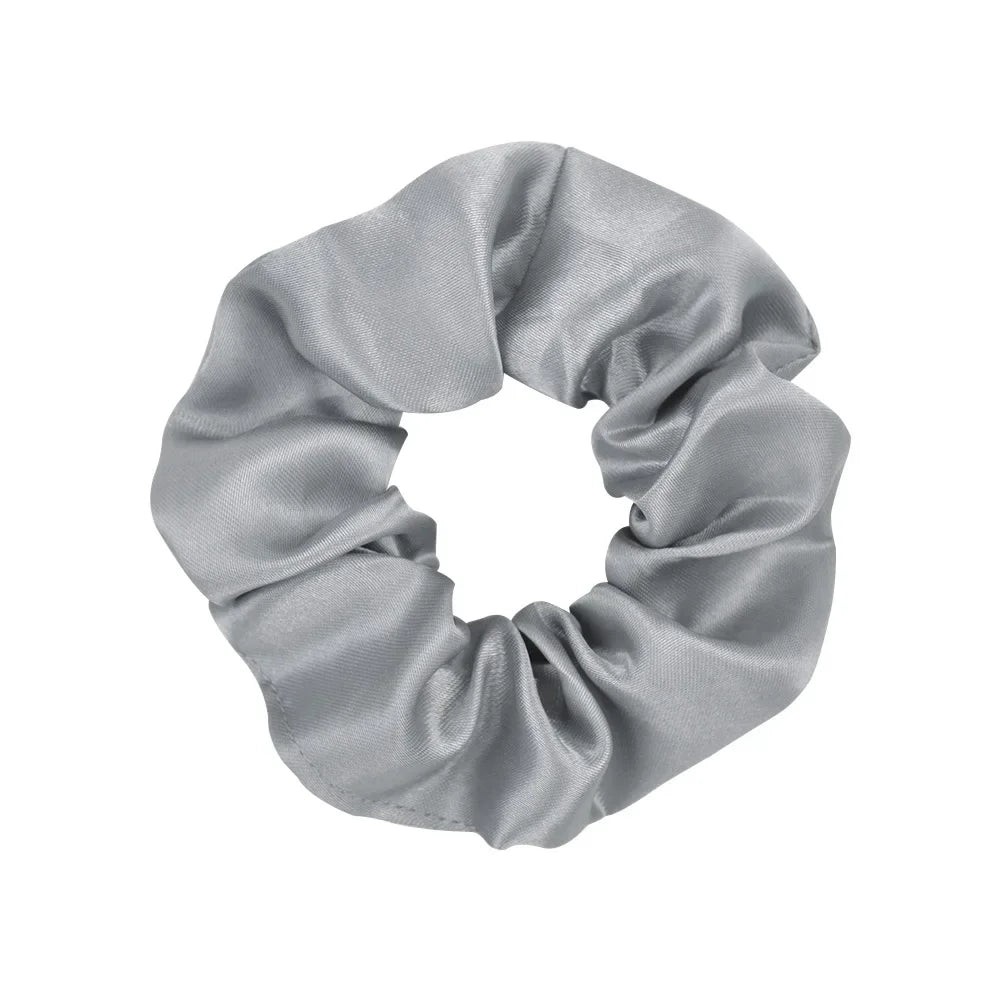 A gray satin scrunchie tied in a voluminous bow shape.
