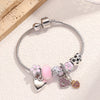 Silver beaded love bracelet set featuring pink and purple stones and charms