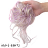 A hand holds a bundle of light purple and white synthetic hair, styled into a loose bun or ponytail.