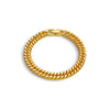 A gold-toned Cuban link bracelet made of stainless steel, shown against a white background.