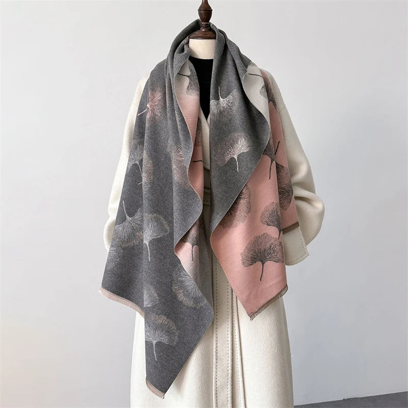 A gray and pink plaid cashmere feel scarf draped over a white garment.