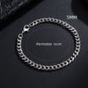 A silver stainless steel Cuban link bracelet shown on a dark background with a 5mm chain and an 18cm perimeter.