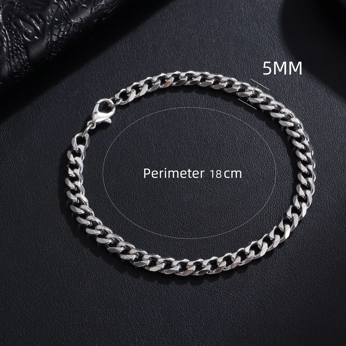 A silver stainless steel Cuban link bracelet shown on a dark background with a 5mm chain and an 18cm perimeter.