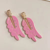 Pair of pink angel wing hair clips with gold-toned barrettes and small rhinestones
