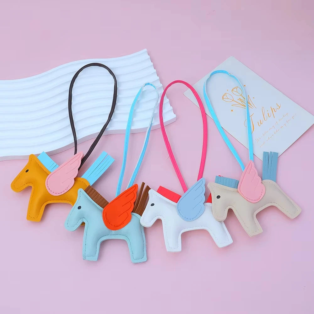 A set of elegant horse pendant charms in various pastel colors including yellow, blue, pink, and white.