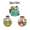 A set of three enamel brooches featuring cute green animals in glass bottles.