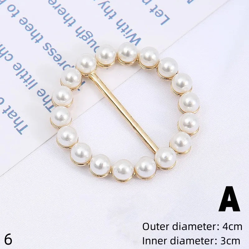 A gold-toned bracelet made of small white pearls with a thin gold chain and a decorative clasp.