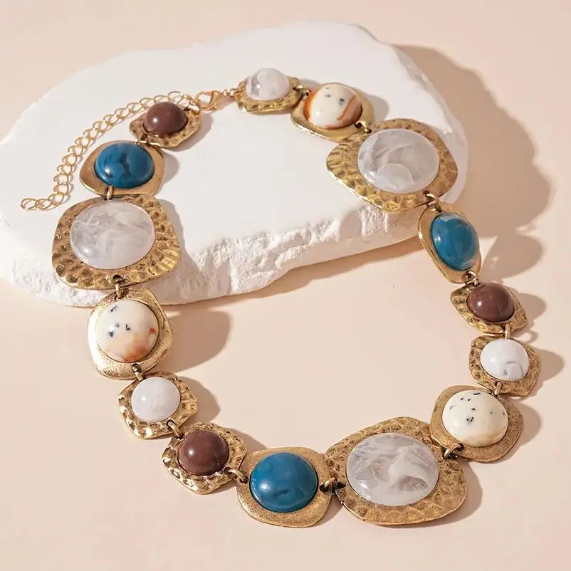 Boho gold plated resin statement choker necklace featuring round beads of blue, white, and brown stones