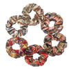 Set of six satin floral print scrunchies for hair in various colors and patterns