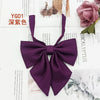 A deep purple solid cotton bow tie shown against a white background.