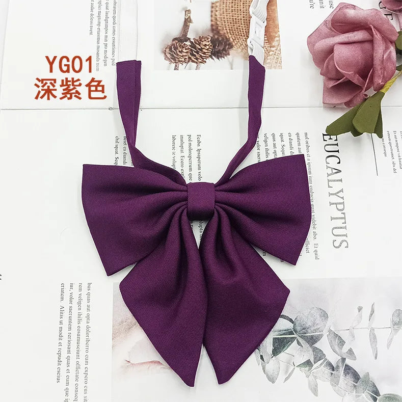 A deep purple solid cotton bow tie shown against a white background.