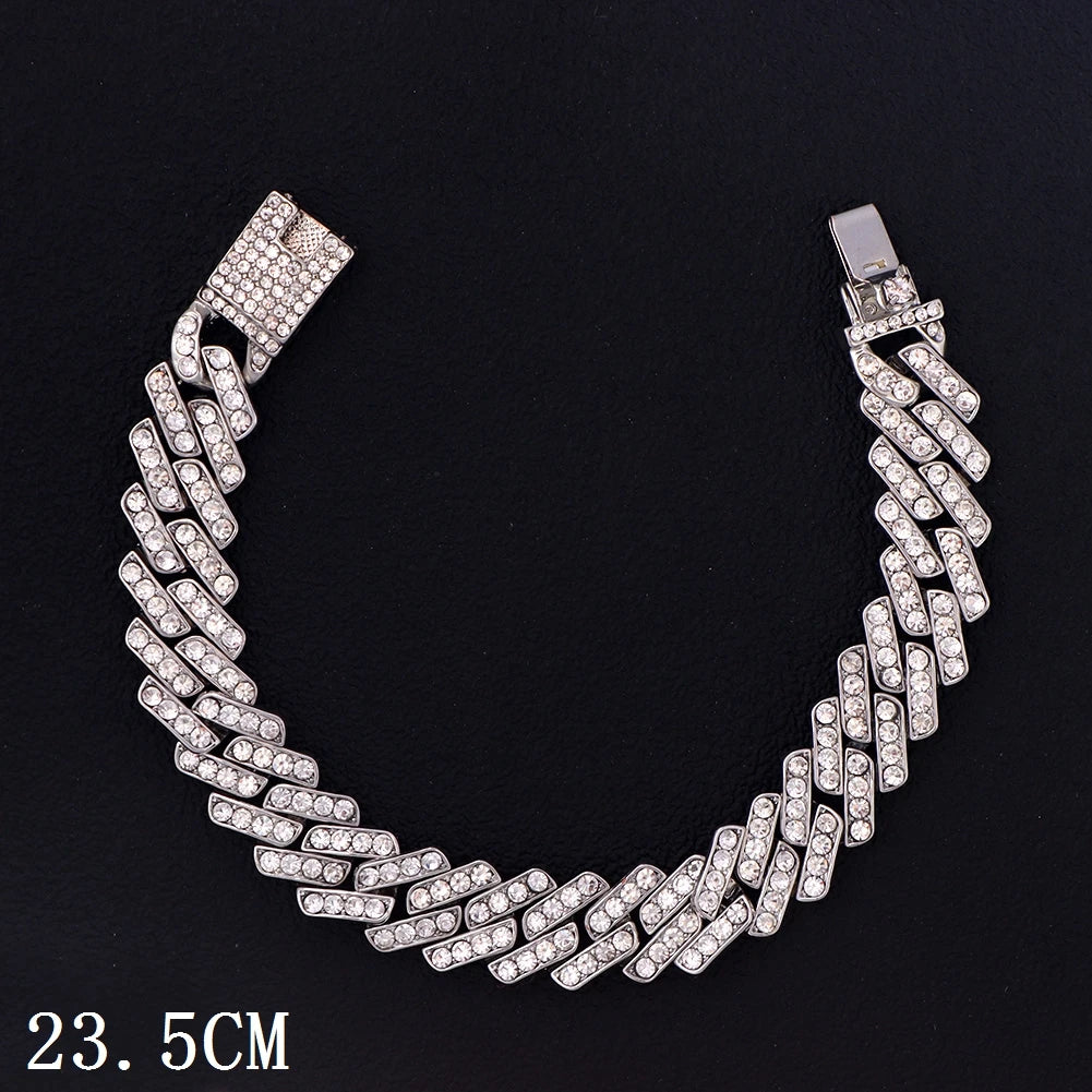 A silver crystal Cuban link anklet featuring a textured chain design.
