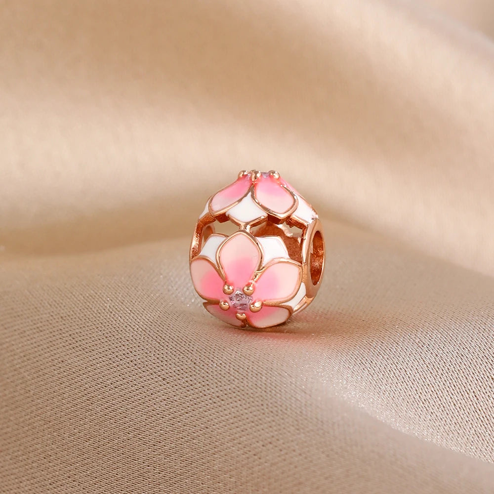 Rose gold cherry blossom charm pendant with pink and white floral design